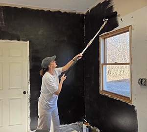 inside Laura painting door of world synergy's new location